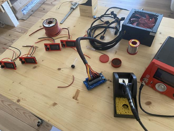 PSU during the building process. Tin, soldering station, computer PSU and the four section are present